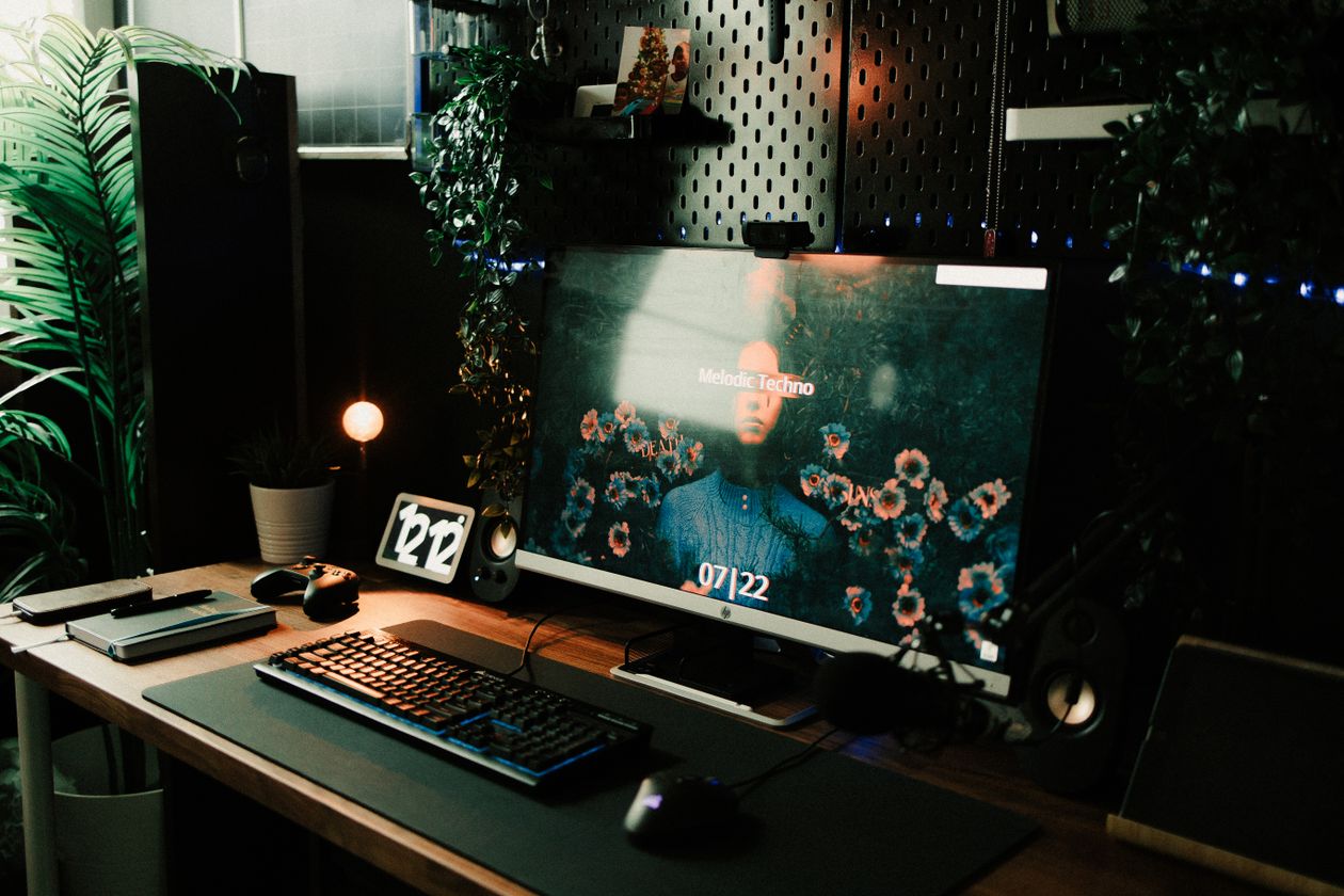 Tidy home office desk with a keyboard and an open notebook