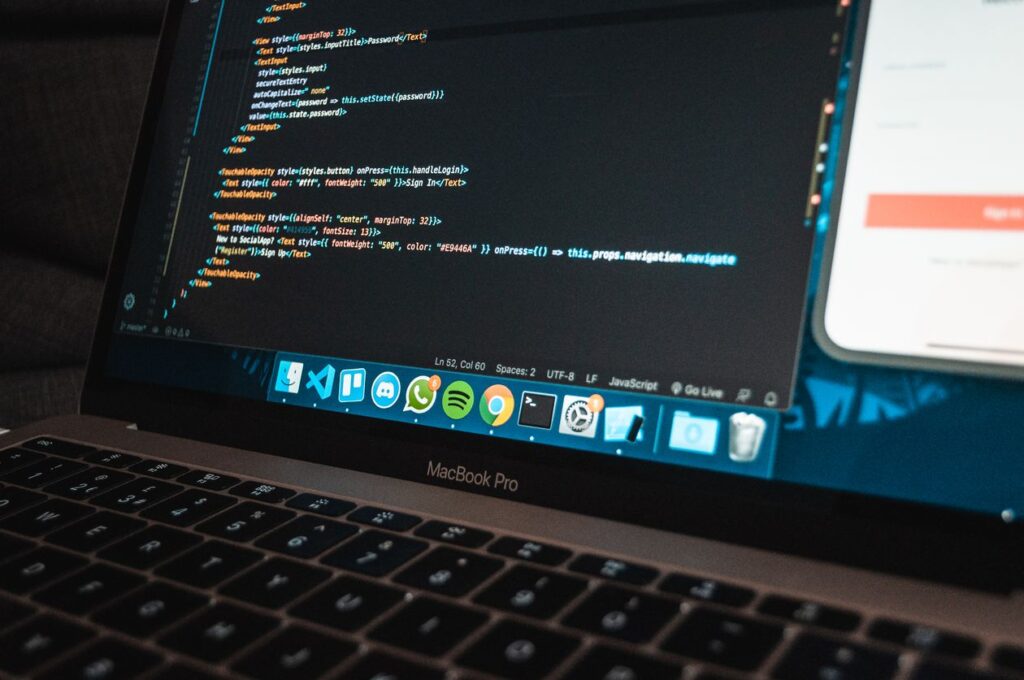 Laptop on a desk showing Dart code in a tidy workspace