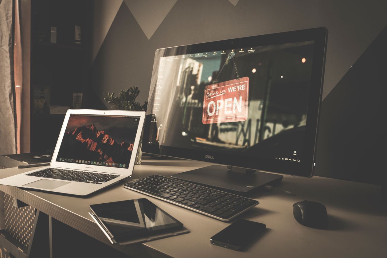 Tidy developer desk workspace with laptop, keyboard and notebook